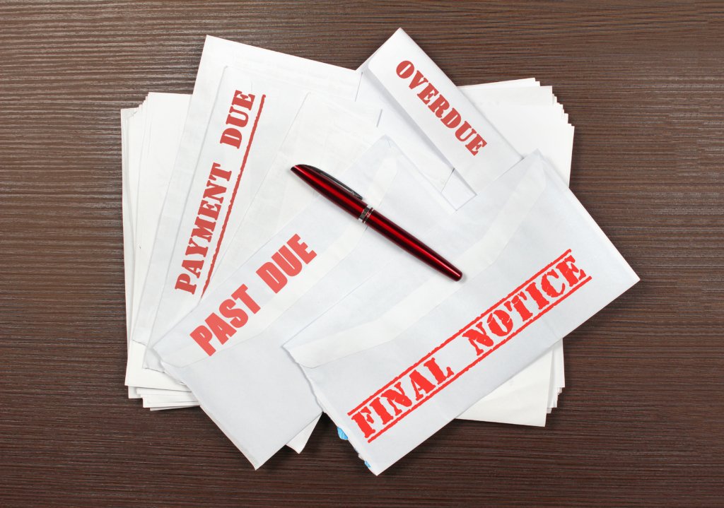 a pile of of bills to represent timesahre maintenance fees which never end and always increase