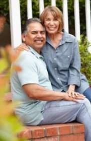 Smiling couple sitting together outdoors after resolving a difficult timeshare situation